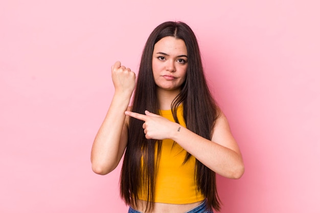 Looking impatient and angry pointing at watch asking for punctuality wants to be on time