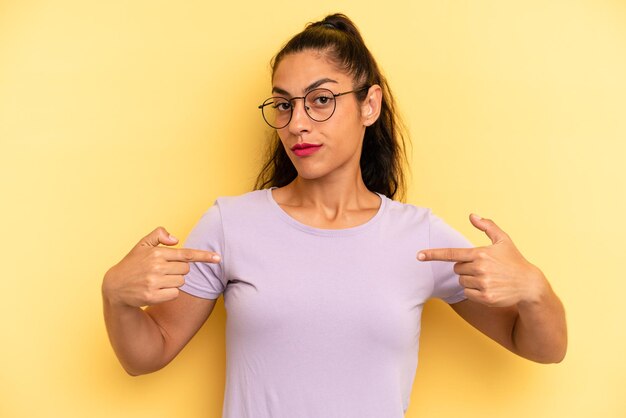 Looking proud positive and casual pointing to chest with both hands