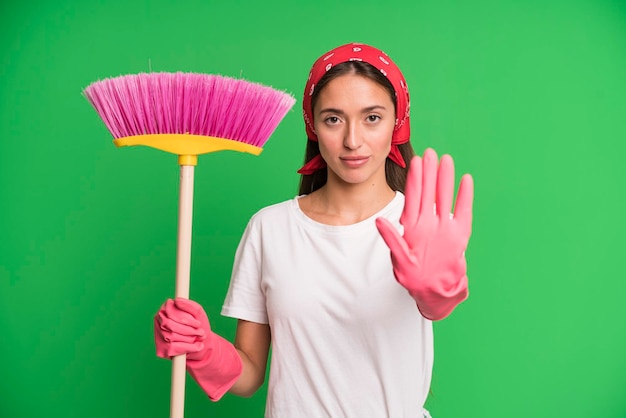 Looking serious showing open palm making stop gesture