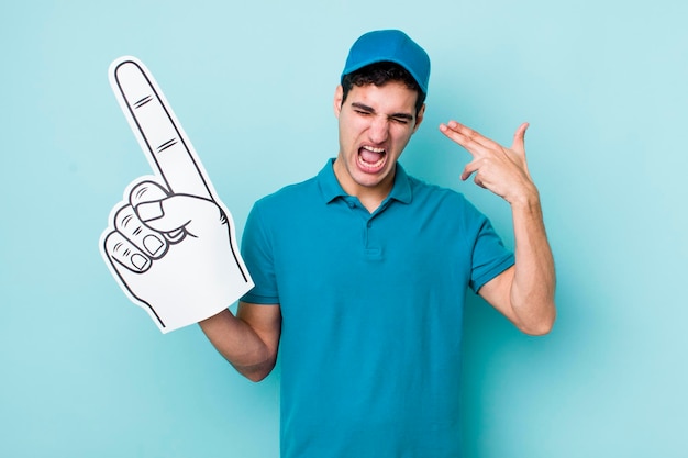 Looking unhappy and stressed suicide gesture making gun sign