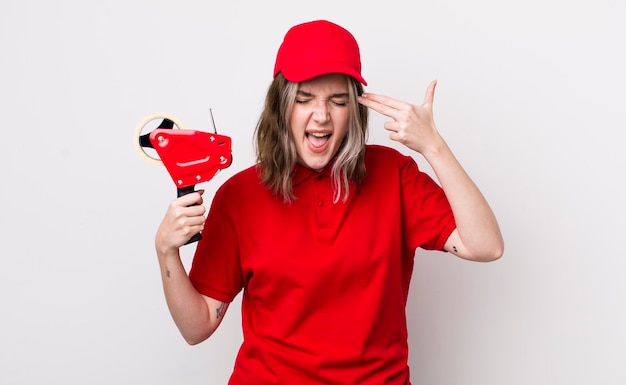 Looking unhappy and stressed suicide gesture making gun sign