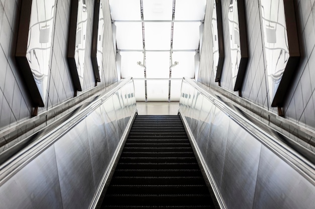 Looking up a moving escalator at subway station