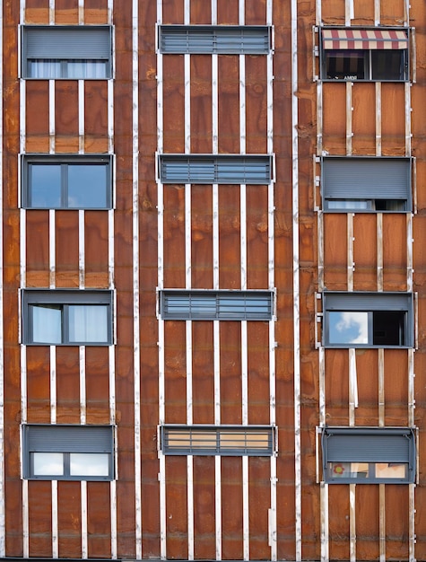 Looking up at a tower block that has had its cladding removed being repaired Vintage facade