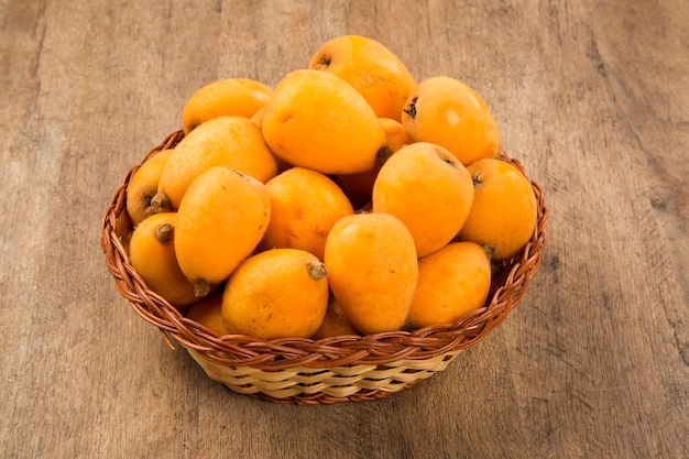 Loquat Medlar fruit on wooden space. Fresh fruits.