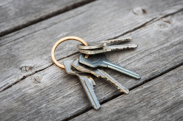 A lost bunch of keys lies on the wooden floor