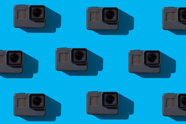 a lot of action cameras on a blue background Videography concept