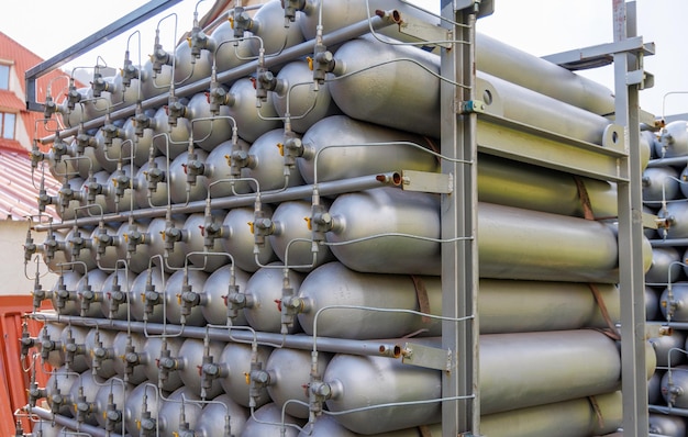 A lot of bottles filled with gas or gasoline are stacked in piles