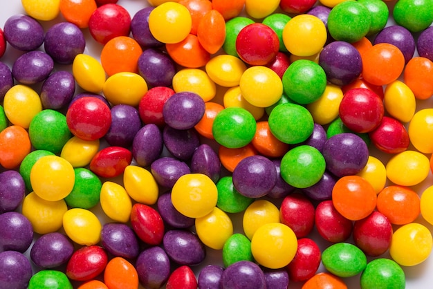 Lot of bright sweet candy, colored background