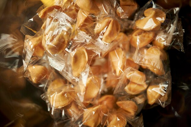 a lot of chinese fortune cookies background. cellophane wrapped fortune cookies, top view