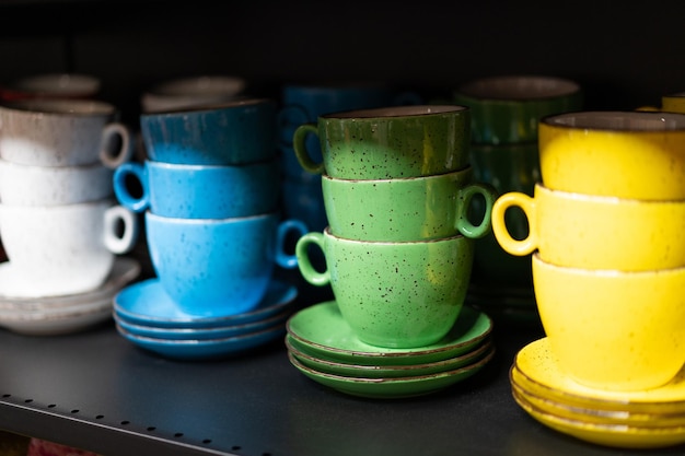 A lot of colored cup on the shelf