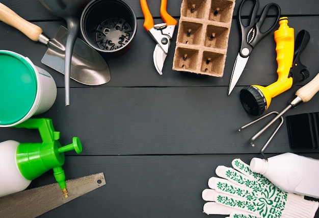 A lot of different garden equipment on the wooden table