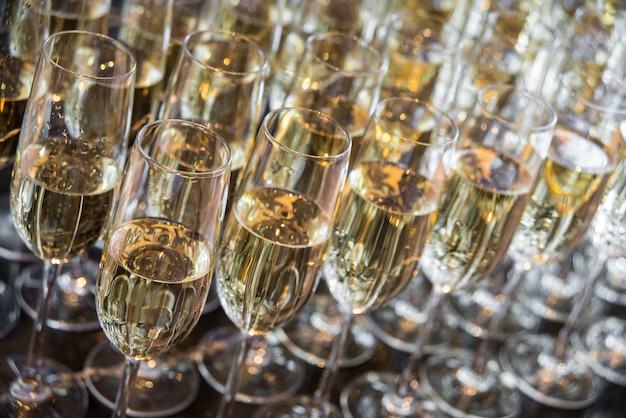 A lot of glasses with champagne stand in a row. glasses with champagne closeup