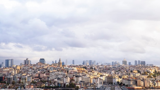 A lot of low residential and high modern buildings in the distance, Galata tower at cloudy weather Istanbul, Turkey