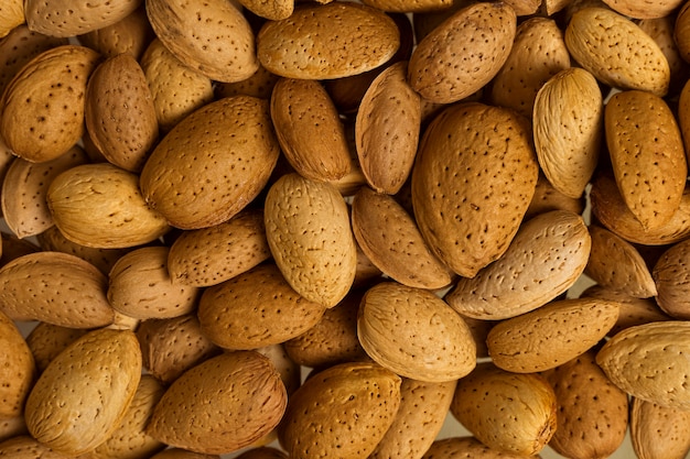 A lot of nuts close-up. unpeeled almonds. natural background for healthy eating concept