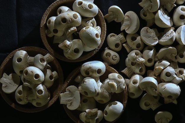 lot of skulls background, abstract texture mushrooms champignena natural decoration for the holiday food halloween day of the dead