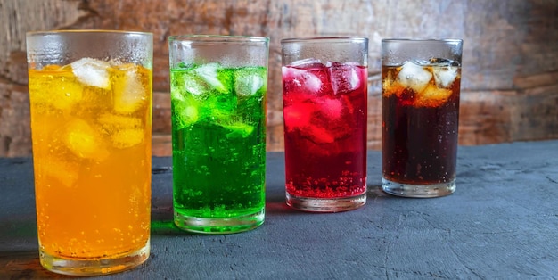 A lot of Soft drinks in colorful and flavorful glasses on the table sweet drinks with ice