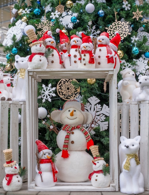 A lot of toys snowmen, deer, bears and fox, standing under the tree, Christmas toys,