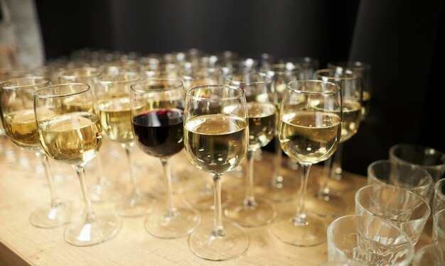 A lot of wine glasses with a cool delicious champagne or white wine at the bar