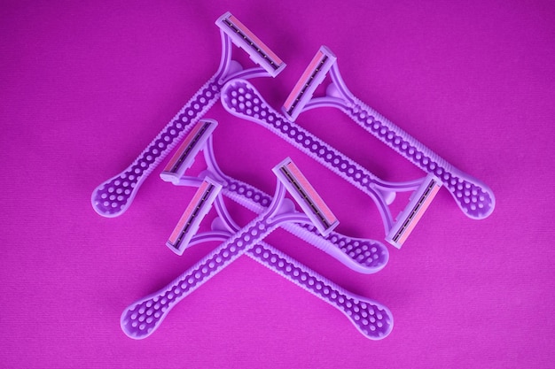 A lot of women's razors on a pink background