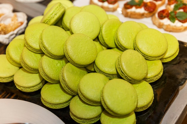 Lots of green macarons on the buffet table Holiday breakfasts and coffee breaks Closeup