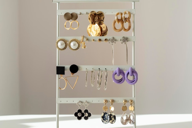 Lots of modern women's earrings on a stand Beautiful women earrings