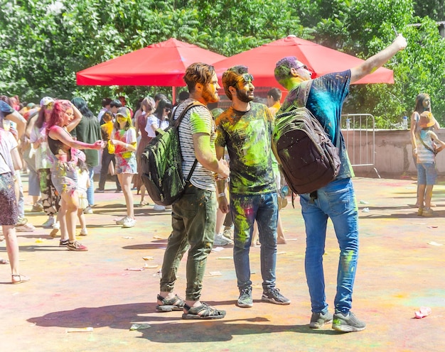 the lots of people in the color fest colored faces of the peoples color festival in india