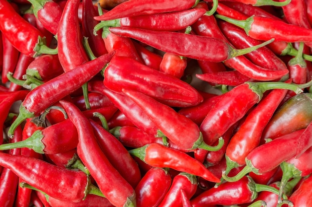 lots of ripe red peppers as a natural background for vegetables