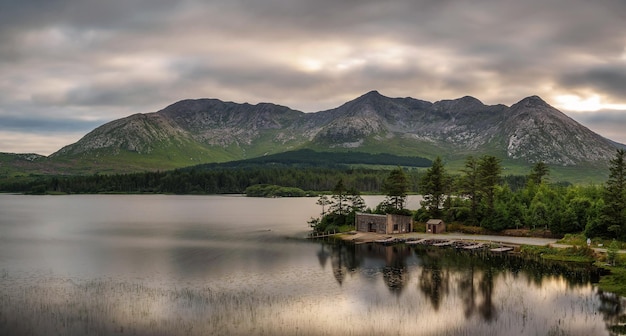 Lough Inagh in Ireland with a cabin and boats at the lake shore