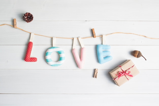 Love alphabets with gift box on vintage white wooden background, Top view love concept