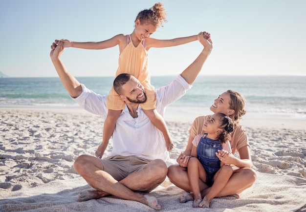 Love beach and a happy family bonding in sand playing and having fun on summer vacation in Mexico Kids parents and ocean view with excited girl enjoying playful game with her mother and father