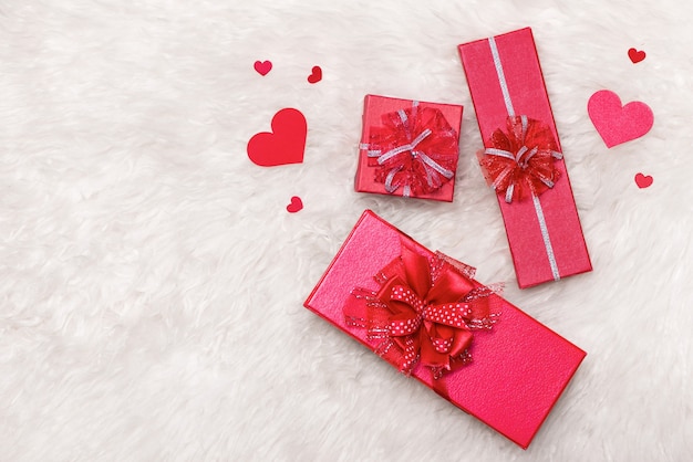 Love Concept. Top view of red gift boxes with bow.