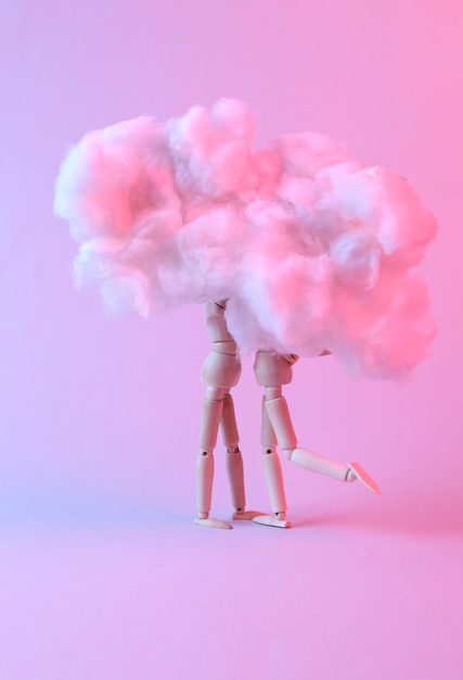 Love concept Two puppets are kissing in the cloud Pink blue neon light Valentine's Day Minimalism Creative idea