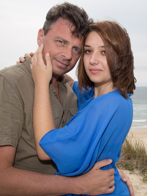 In love couple embracing on the beach on a sunny day