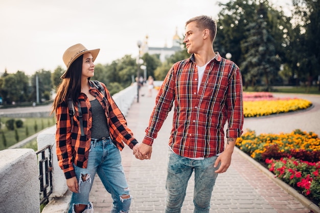 Love couple of tourists holding hands