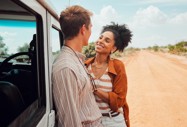 Love couple travel and smile for road trip in the countryside on desert vacation in nature Happy man and woman smiling for relationship traveling and adventure for holiday bonding in the outdoors