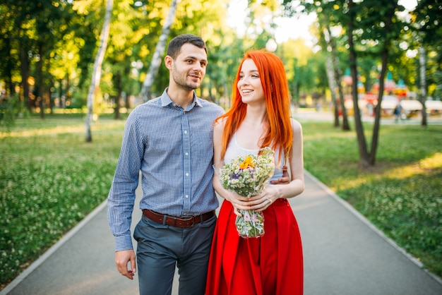 Love couple walk and hugs in summer park