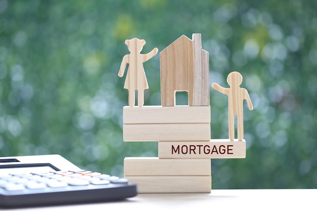 Love couple with model house and calculator on natural green background