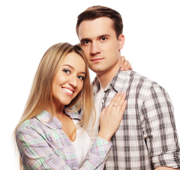 Love, family and people concept: lovely happy couple hugging over white background.