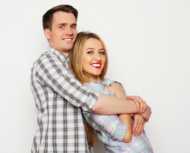 Love, family and people concept: lovely happy couple hugging over white background.