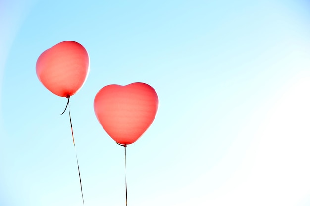 Love heart balloons on sky background