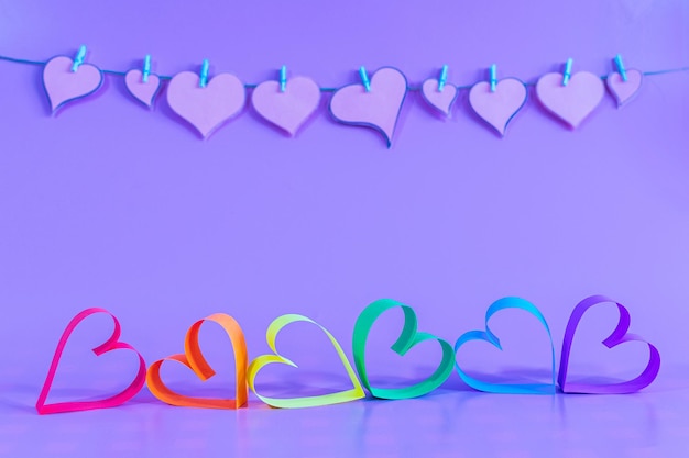 Love hearts with the colors of LGBT on blue background