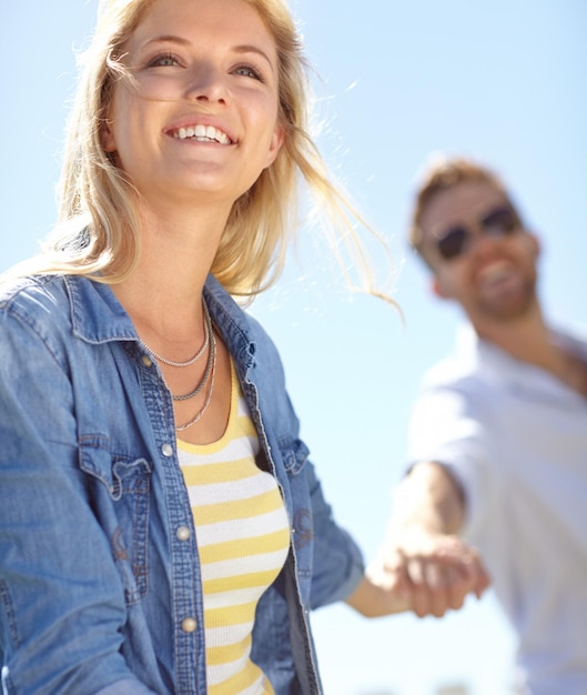 Love holding hands and couple walking happy and enjoy outdoor quality time together bond and fun romantic date Freedom peace and happiness for man and woman on summer holiday in Lisbon Portugal