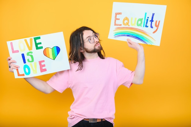 Love is love Attractive gay caucasian man holding a protest sign during a LGBT pride parade