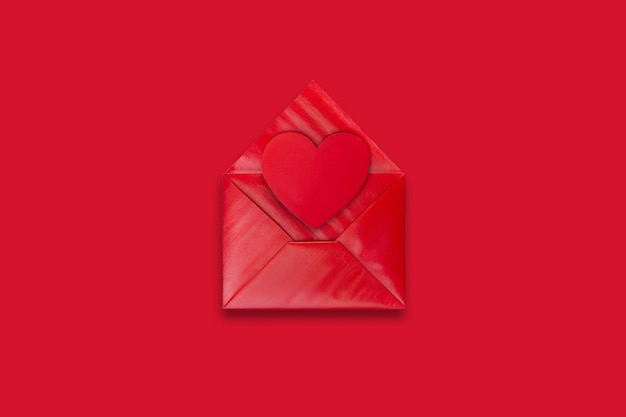 Love letter red envelope with red valentine heart on red background