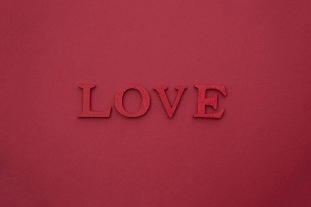 LOVE lettering, 3D wooden red letters on red. Creative Valentine's Day