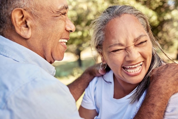 Love park and senior couple laugh have fun and enjoy bonding quality time together on outdoor nature date Retirement lifestyle funny and excited man and woman on marriage anniversary vacation