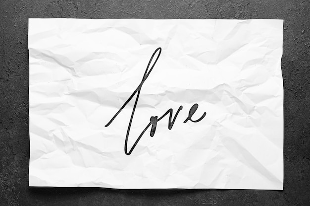 Love Don't quit Lettering on crumpled white paper Handwritten text Inspirational quotes