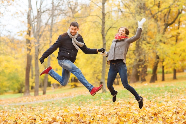 love, relationship, family and people concept - smiling couple having fun in autumn park