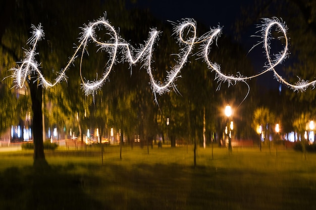 Love sparklers on blurred background Street life relationships concept