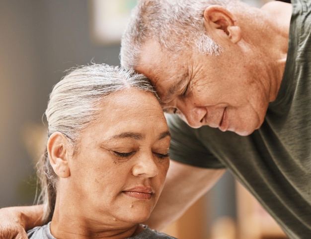 Love support and senior couple hugging bonding and spending quality time together at their home Affection romance and elderly man and woman in retirement embracing with care at their house